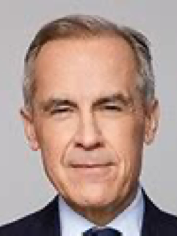 mark carnet with short gray hair wearing a dark suit and tie against a plain background.